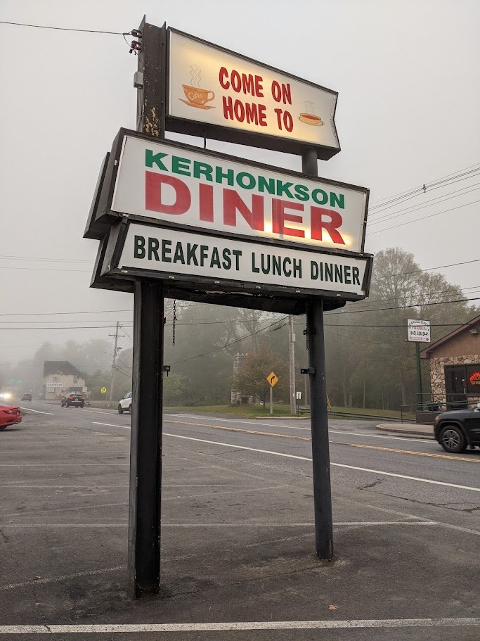Plates of breakfast food on a diner table.